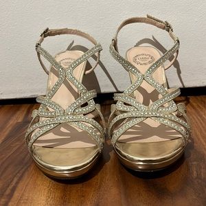 I’m selling gold colored heels, with sparkly gems. And a strap in the back